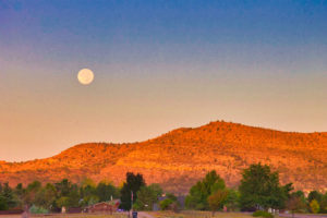 Morning photo of the moon as it sets over the mountains